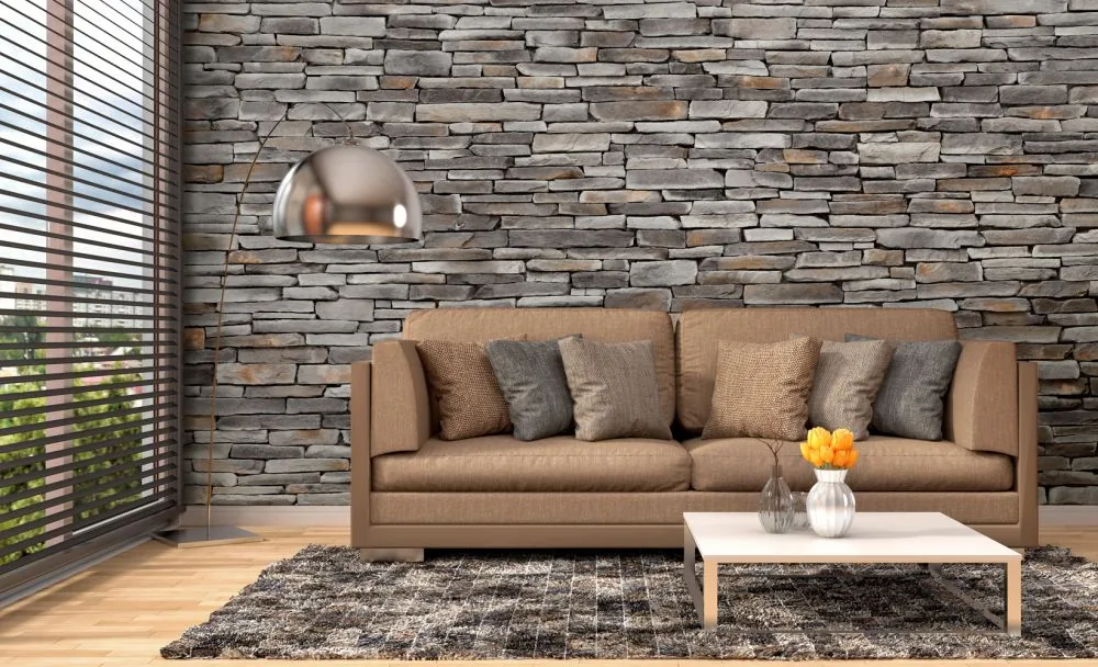 Grey stacked stone feature wall behind a leather sofa